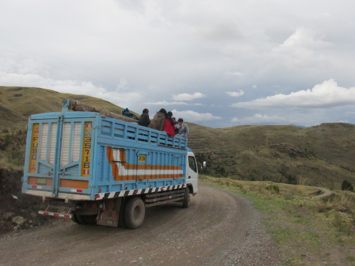 kids riding in bed of truck in Peru to go to school